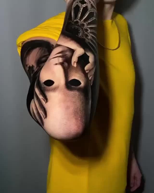 Detailed black and grey realism tattoo of a face on a person's arm.