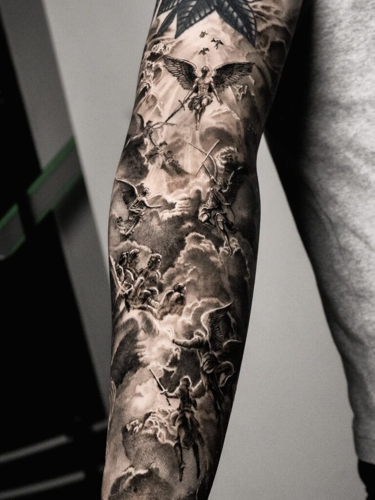 Detailed black and grey sleeve tattoo featuring angels and religious figures among clouds.