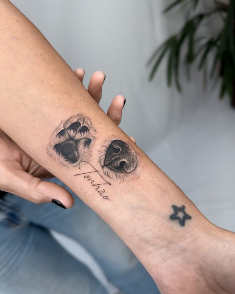 Dog paw and nose tattoos with the name Tonhão on a person's forearm.