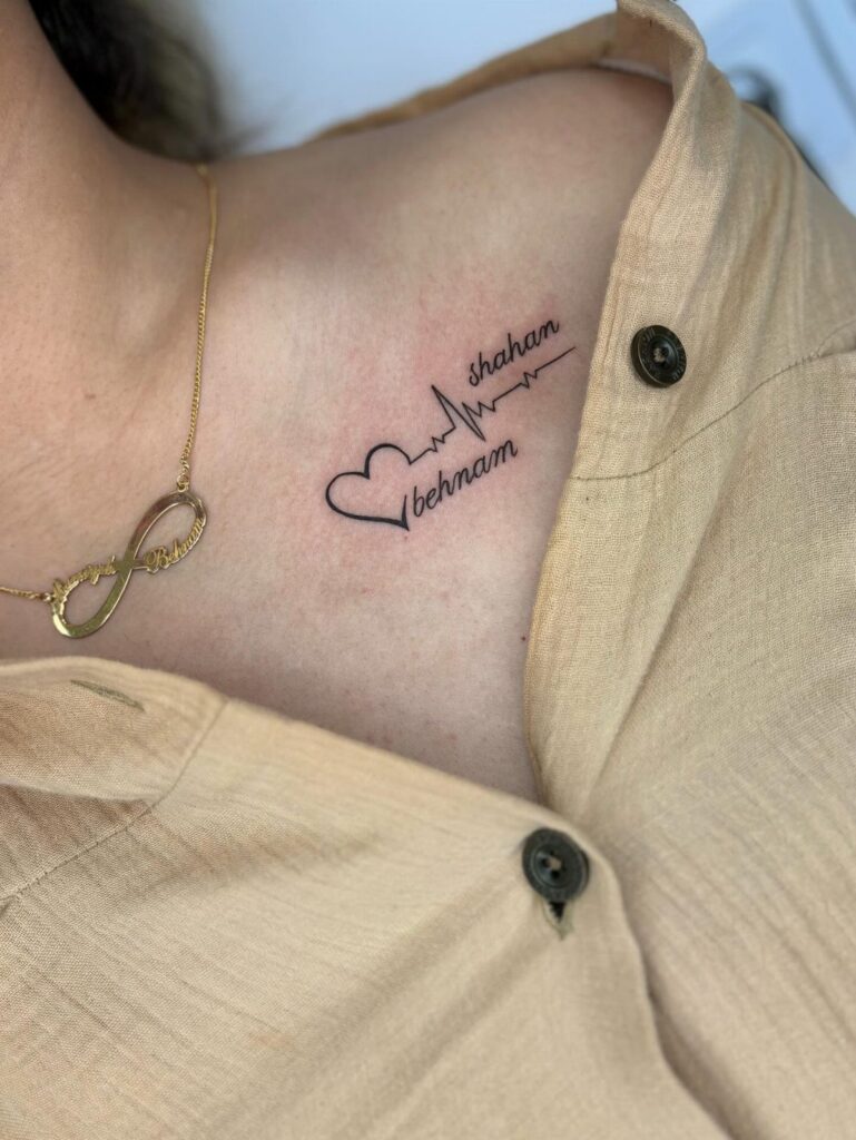 Heartbeat tattoo with a heart and names on a person's collarbone