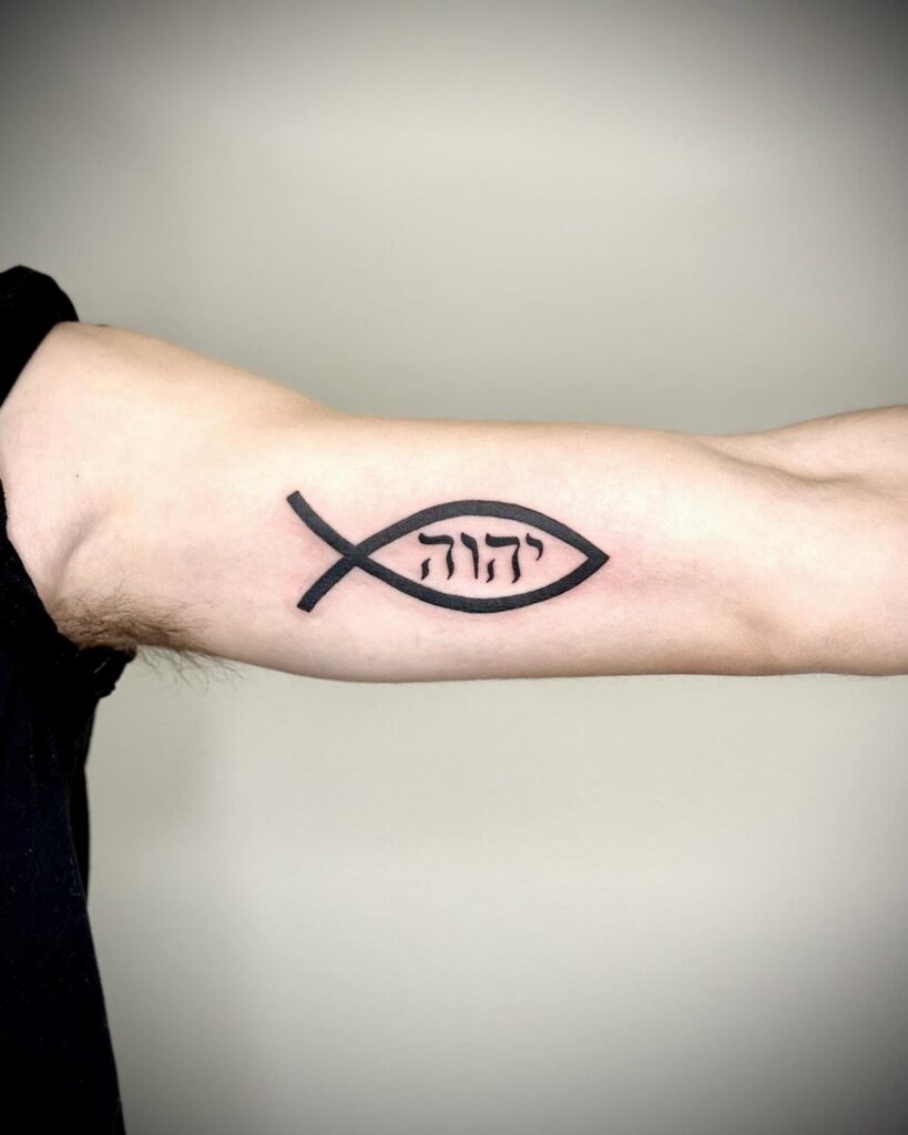 Black ink fish tattoo with Hebrew lettering on a person's forearm