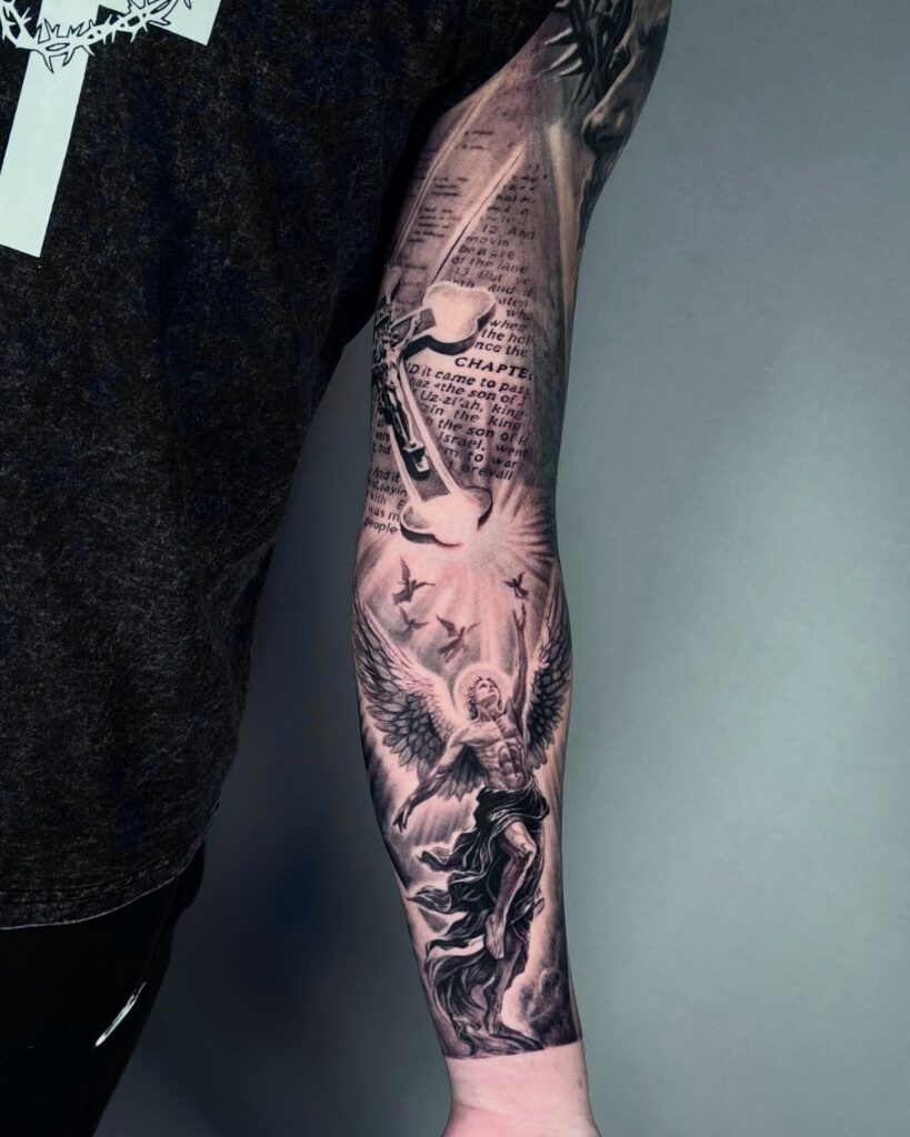 Jesus tattoo with large angel wings and a halo on a forearm