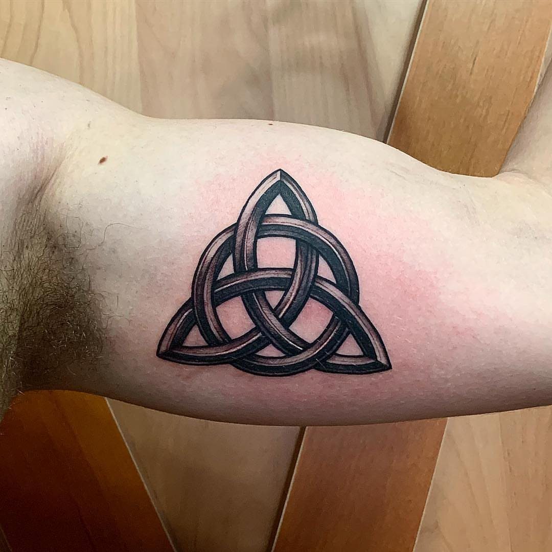 Triquetra Celtic knot tattoo with 3D shading on a person's forearm